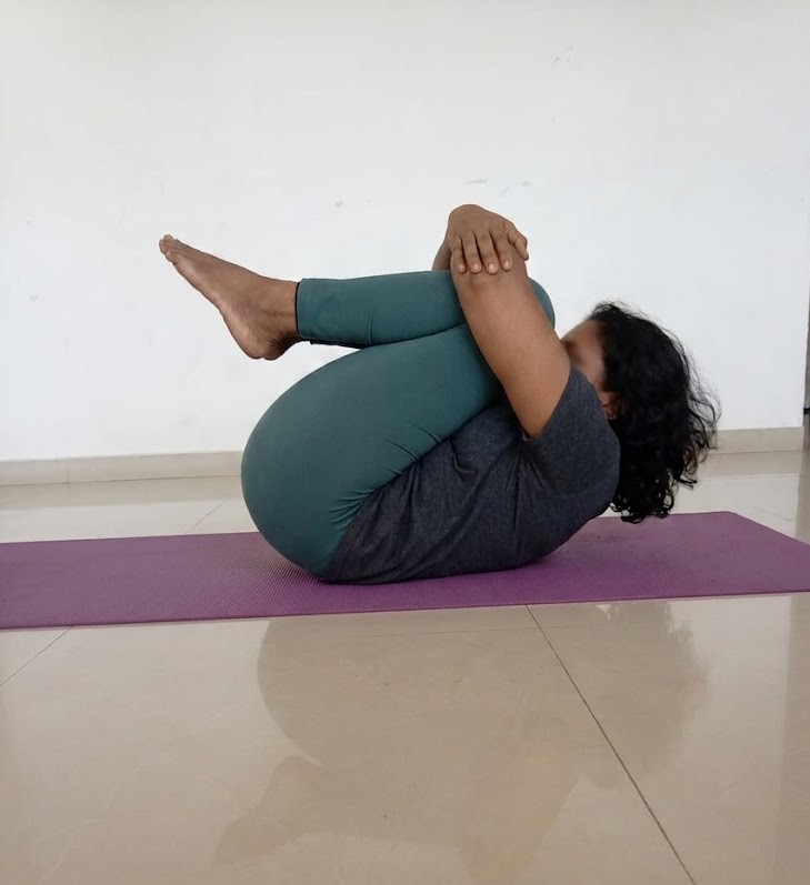 Person in Pavanamuktasana, Wind-Relieving Pose